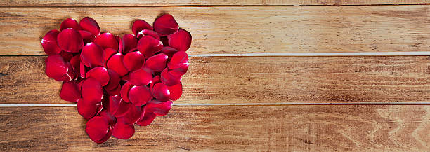 istock Heart shape rose leaves on blank wood 624546026