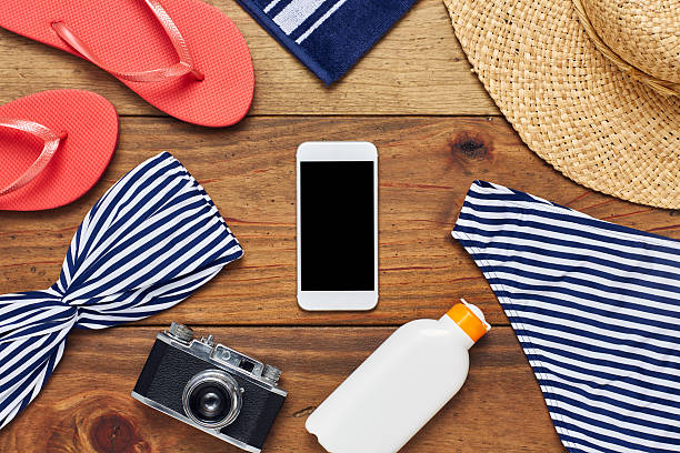 istock Flat lay of smart phone surrounded with beach accessories 624546346