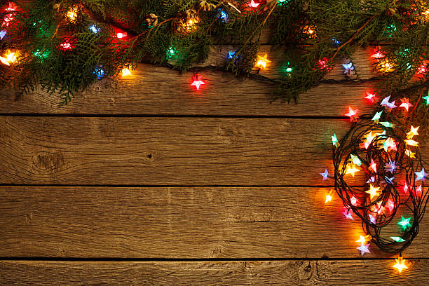 istock christmas lights border on wood background 624546442