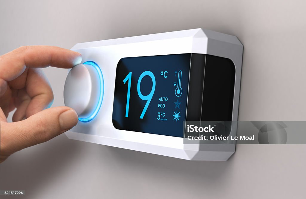 Save Energy, Reducing Electricity Use Hand turning a home thermostat knob to set temperature on energy saving mode. celcius units. Composite image between a photography and a 3D background. Thermostat Stock Photo