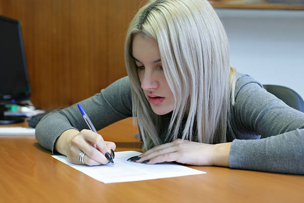 istock Student girl filling an application 624547304