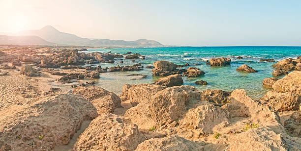 istock rocky beach with mountains at background at sunrise 624547366