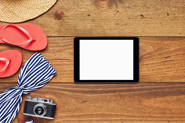 istock Flat lay of tablet computer by summer vacation accessories 624565870