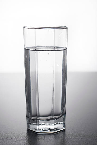 istock Glass of water on table with reflection. 624566696