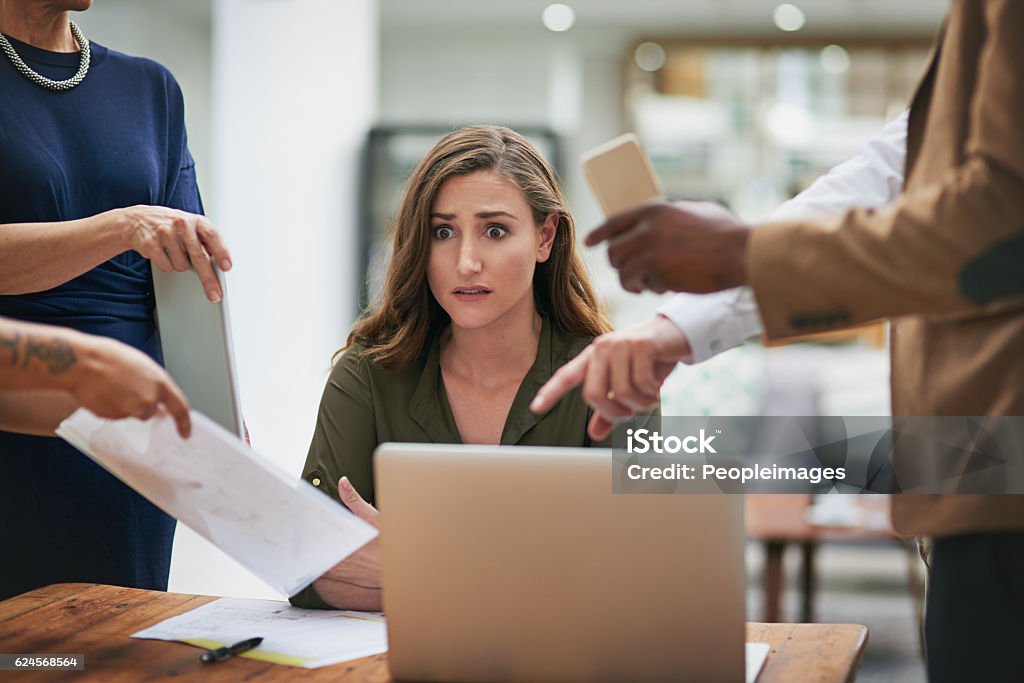 Anxiety is creeping in Shot of a young businesswoman looking anxious in a demanding office environment Emotional Stress Stock Photo