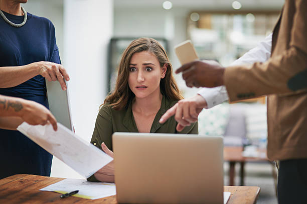 Anxiety is creeping in Shot of a young businesswoman looking anxious in a demanding office environment terrified stock pictures, royalty-free photos & images