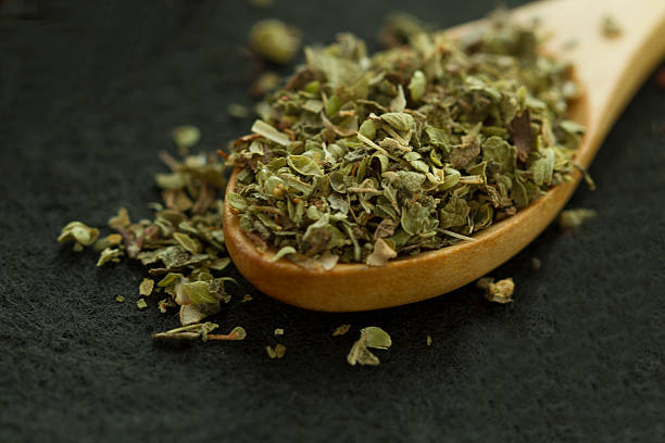 istock Spoon with freen herbs on the black baclground 624568582