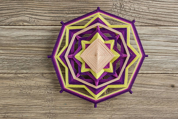 istock Mandala, star of woolen threads, on wooden boards 624569484