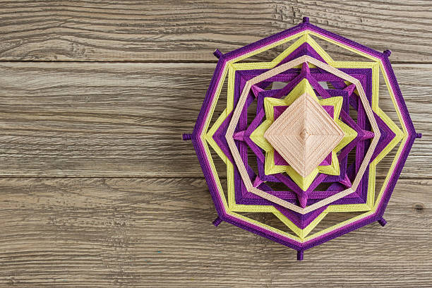 istock Mandala, star of woolen threads, on wooden boards 624569590