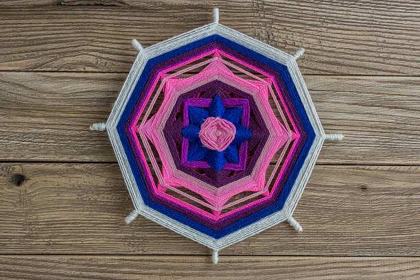 istock Mandala, star of woolen threads, on wooden boards 624569950