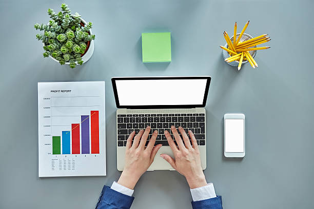 istock Businesswoman hands using laptop surrounded by graph and office 624592706
