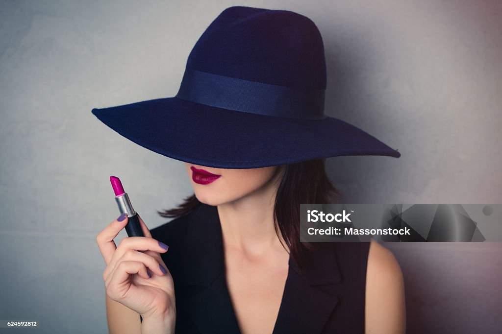 woman in hat with lipstick Portrait of a style brunette woman in hat with lipstick on grey background Diva - Human Role Stock Photo