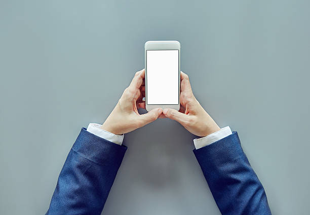 istock Businesswoman hands using smart phone at gray table 624592926