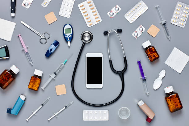istock Flat lay of smart phone surrounded with various medical equipmen 624592974