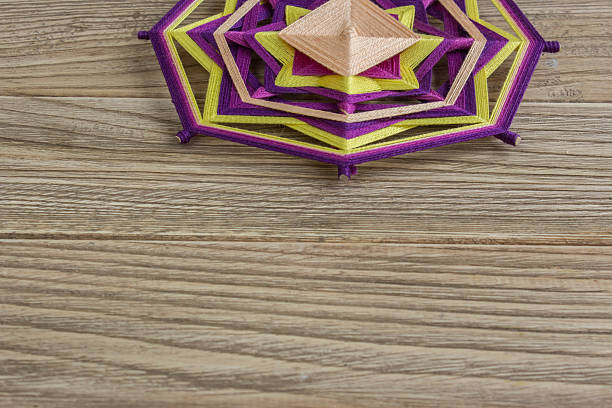 istock Mandala, star of woolen threads, on wooden boards 624593264