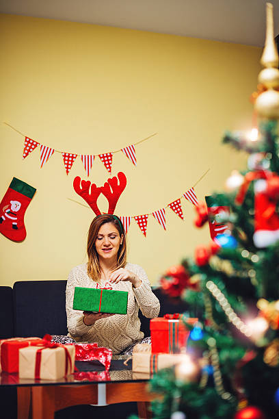 istock Young beautiful woman wrapping Christmas gifts 624616924