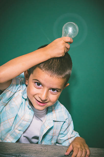 istock Cute little boy holding a bulb 624626668