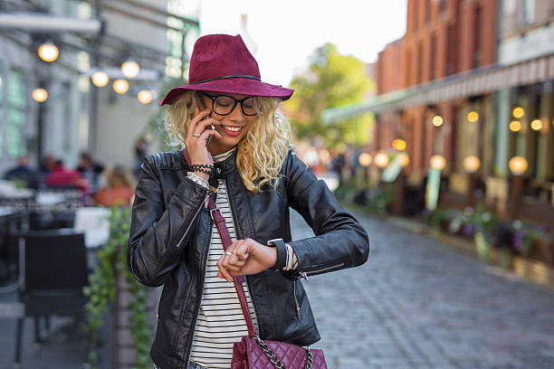 istock Woman talking on the phone and looking at smartwatch 624628742