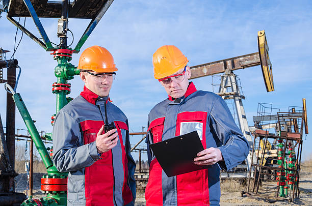 istock Two workers in the oilfield 624629534