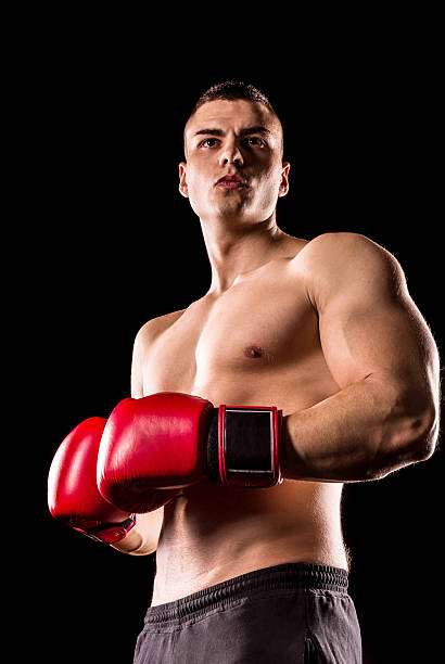 istock boxer man with red boxing gloves isolated on black background 624641942