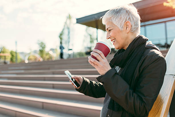 istock Happy Mature Woman Texting Outdoors. 624642676