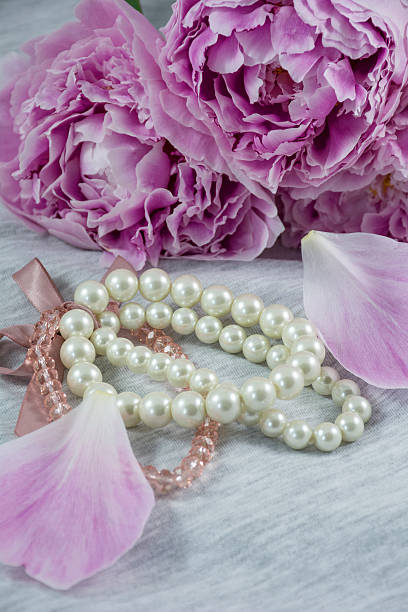 istock One white bracelet with peonies and petals 624643750