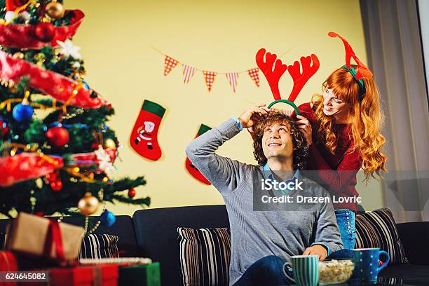 Youll Look Nicer With Santas Hat Tonight Stock Photo - Download Image Now - Adult, Adults Only, Bonding