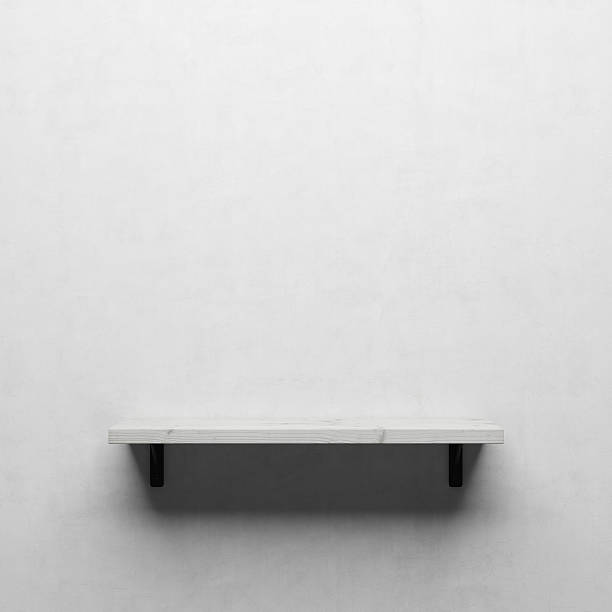 istock White wooden shelf on white wall 624645556