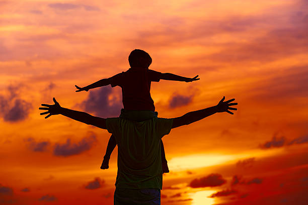 istock father and son having fun at sunset 624650910