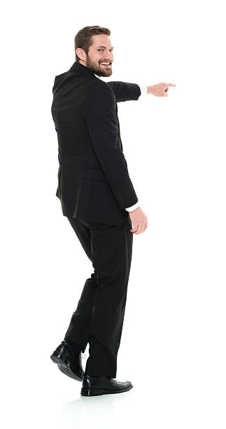 istock Smiling businessman pointing away 624651924