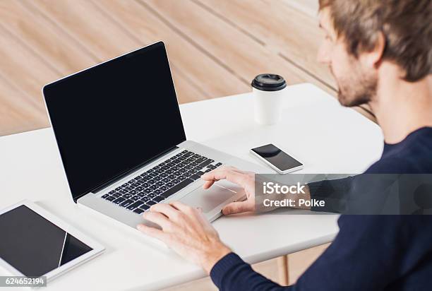 Place Of Work Man Using Laptop Computer Stock Photo - Download Image Now - Computer Monitor, Table, Computer