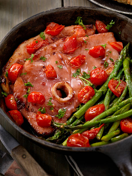 istock Glazed Ham Steak with Asparagus and Tomatoes 624670552