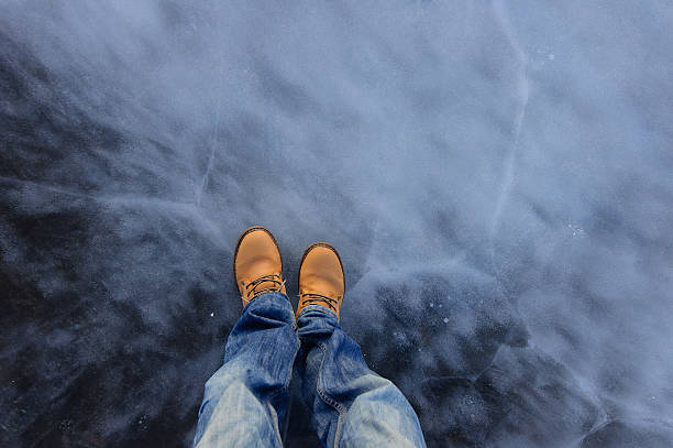 istock Human feet in boots on the ice. Russia 624671600