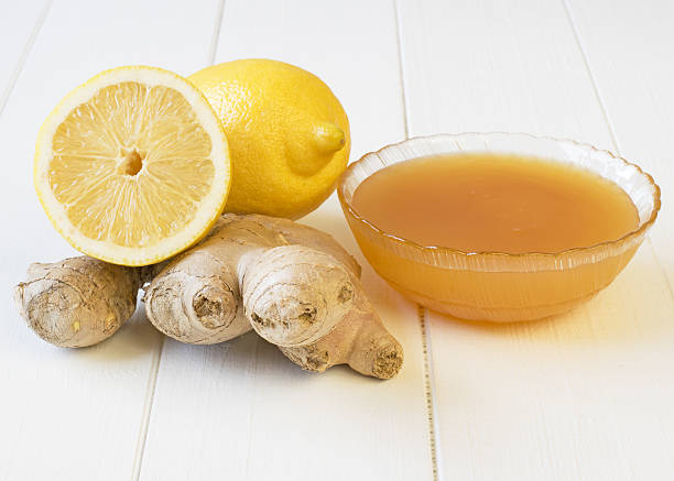 istock The root of ginger and honey on white wooden table. 624671800