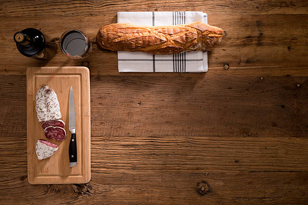 istock flat lay background delicatessen meat wine bread on wood plank 624672046
