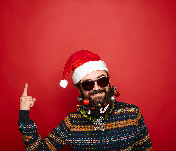 istock Santa Claus pointing in blank red banner, isolated on white 624672398