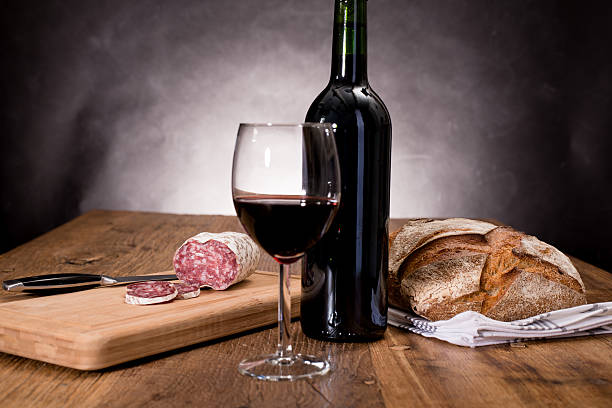 istock flat lay background delicatessen meat wine bread on wood plank 624673386