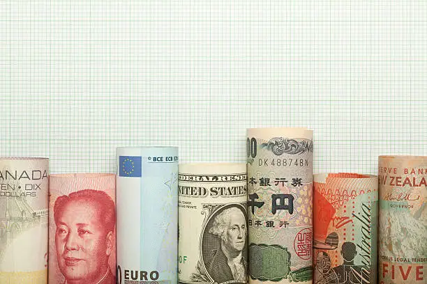 Different currencies forming a graph against grid background