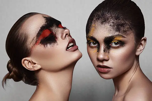Beauty fashion Models with art Makeup on shiny Skin