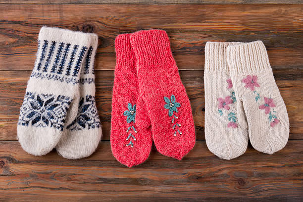 istock Three pairs of knitted handmade woolen mittens. 624675130