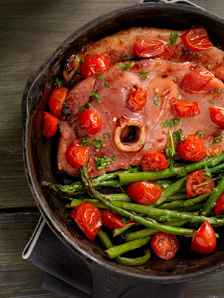 istock Glazed Ham Steak with Asparagus and Tomatoes 624676488