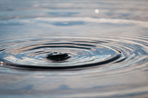 istock Water Drop Falling Onto The Surface Of A Pond 624676948