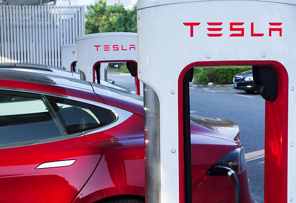 Tesla supercharger parking Shenzhen. China - November 15, 2016: Tesla model S cars charging their battery with the Tesla supercharger station near Shenzhen sport arena. Tesla is an American automotive and energy storage company that designs, manufactures and sells luxury electric cars shenzhen technology stock pictures, royalty-free photos & images