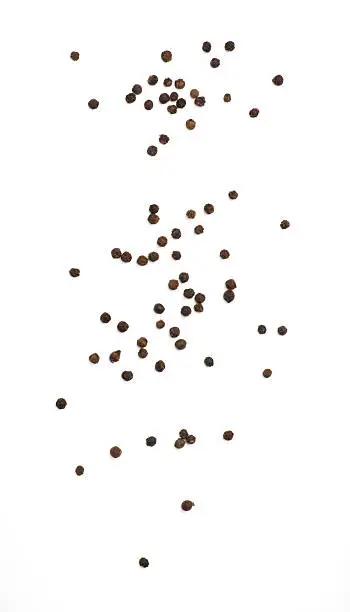 Black pepper isolated on white background. Spices. Top view.