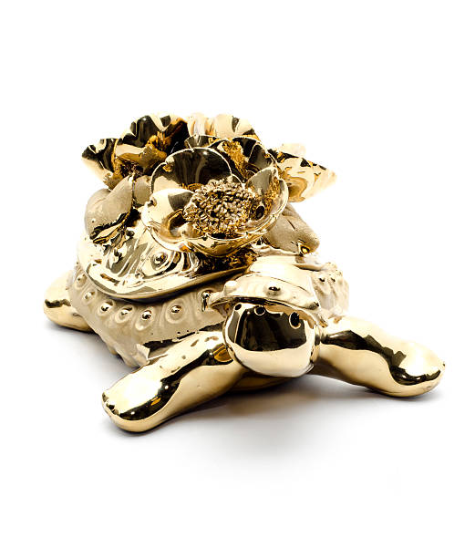 istock Porcelain golden turtle, isolated on white background. 624680526