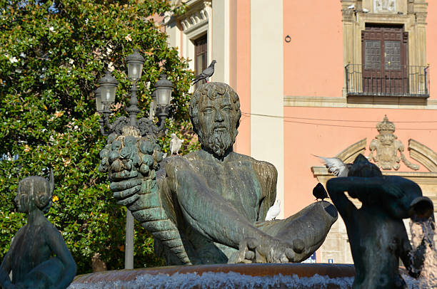 Valencia, Spain - May 22, 2016: Statue of the River God Triton in the Plaza de la Virgen (Square of the Virgin) in the old city of Valencia, Spain
