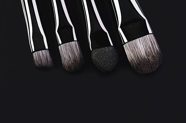 istock four makeup brushes close-up on a black background. horizontal 624682800