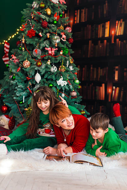 istock Family Book Reading near Christmas Tree 624684794