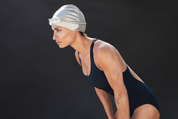 istock Professional female swimmer on black background 624684802