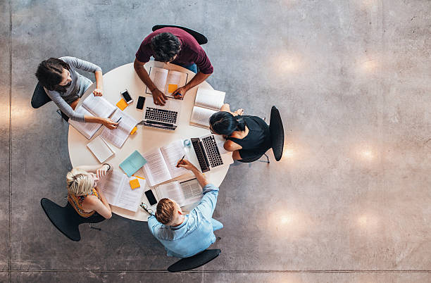 University students doing group study Top view of group of students sitting together at table. University students doing group study. five people stock pictures, royalty-free photos & images